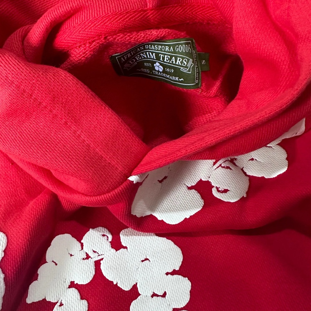 Denim Tears Red Hoodie with White Floral Design